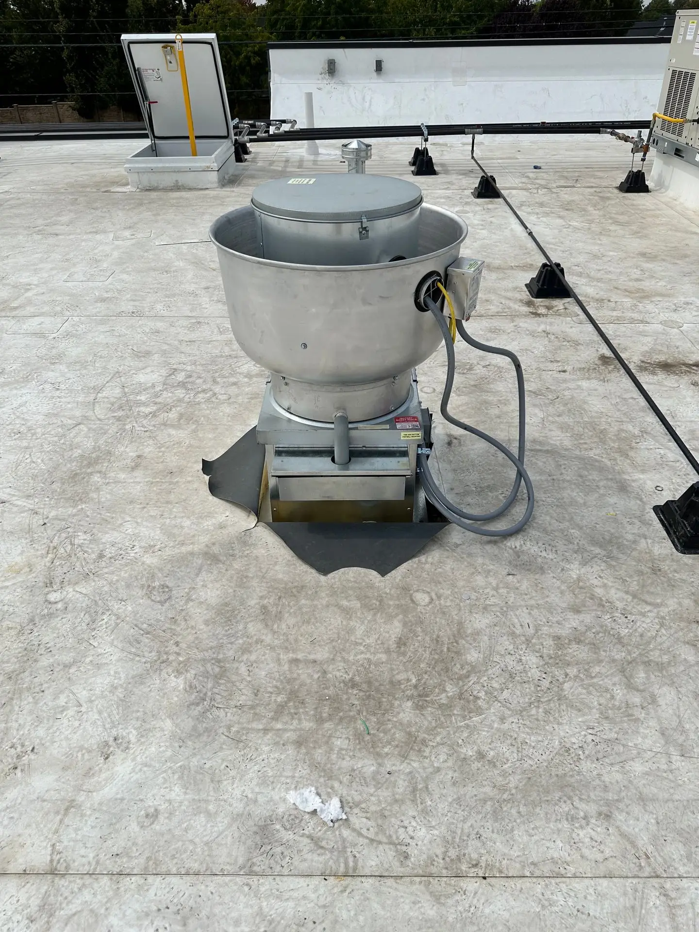 New upblast exhaust fan on a restaurant roof