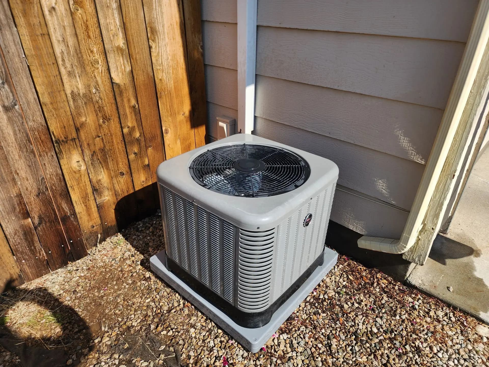New condenser installed beside a cedar fence at a Treasure Valley home