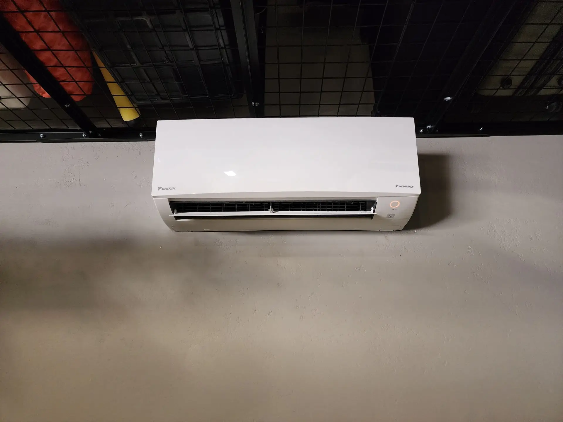 Ductless mini-split head mounted in a commercial gym space