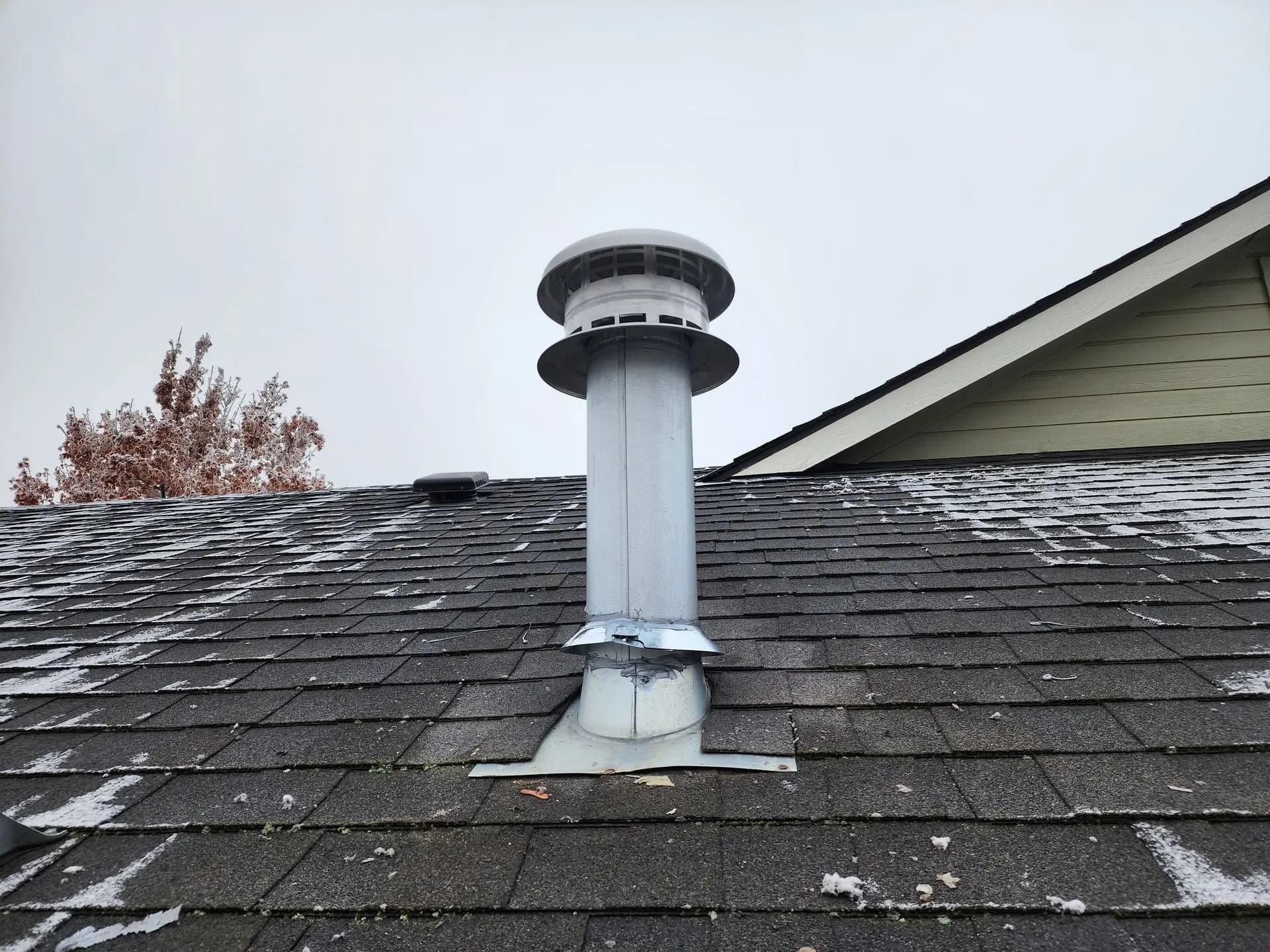 New flue and storm collar on a frosty roof